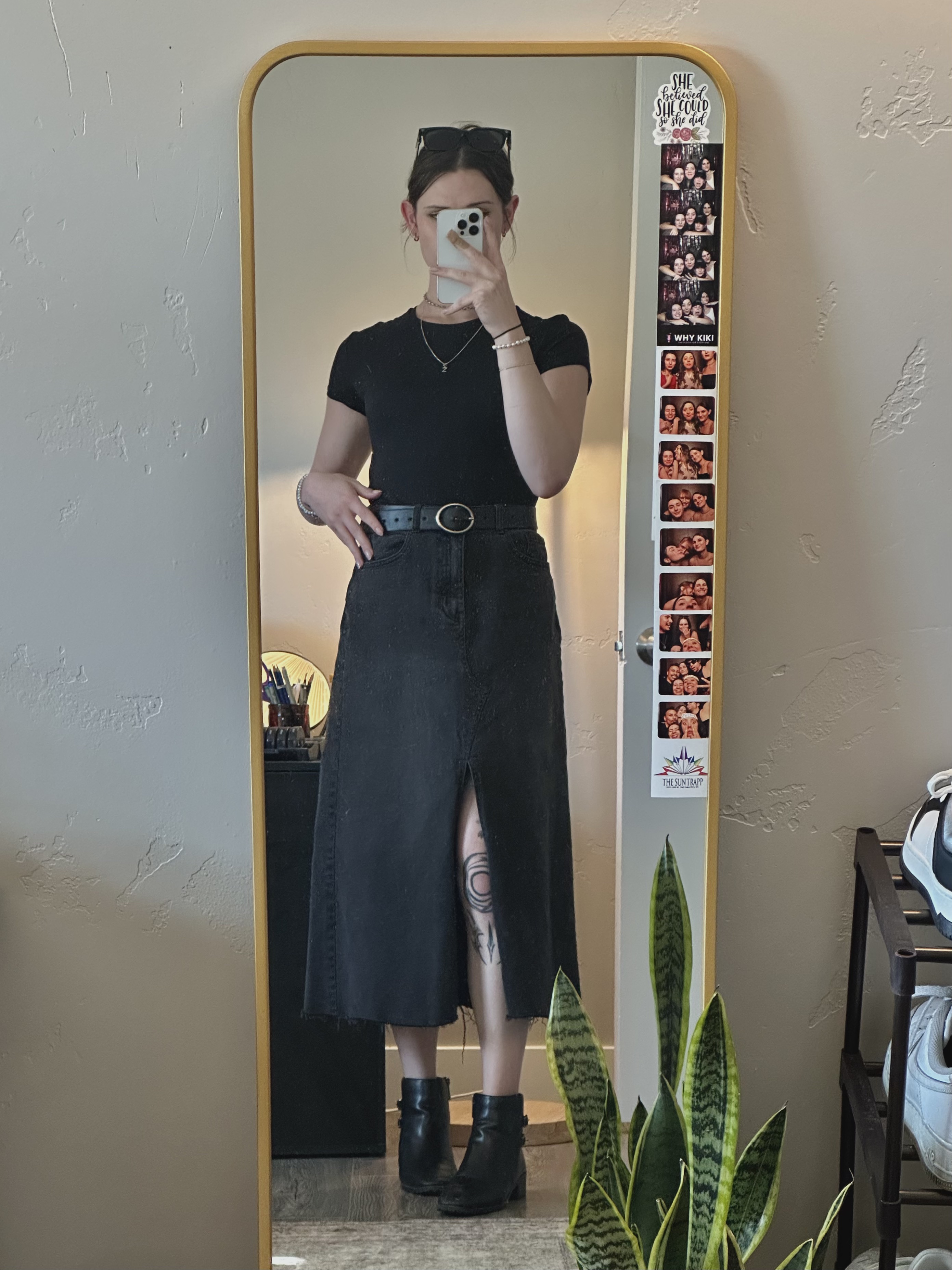 Mirror selfie of Zoe in a black denim skirt and baby tee