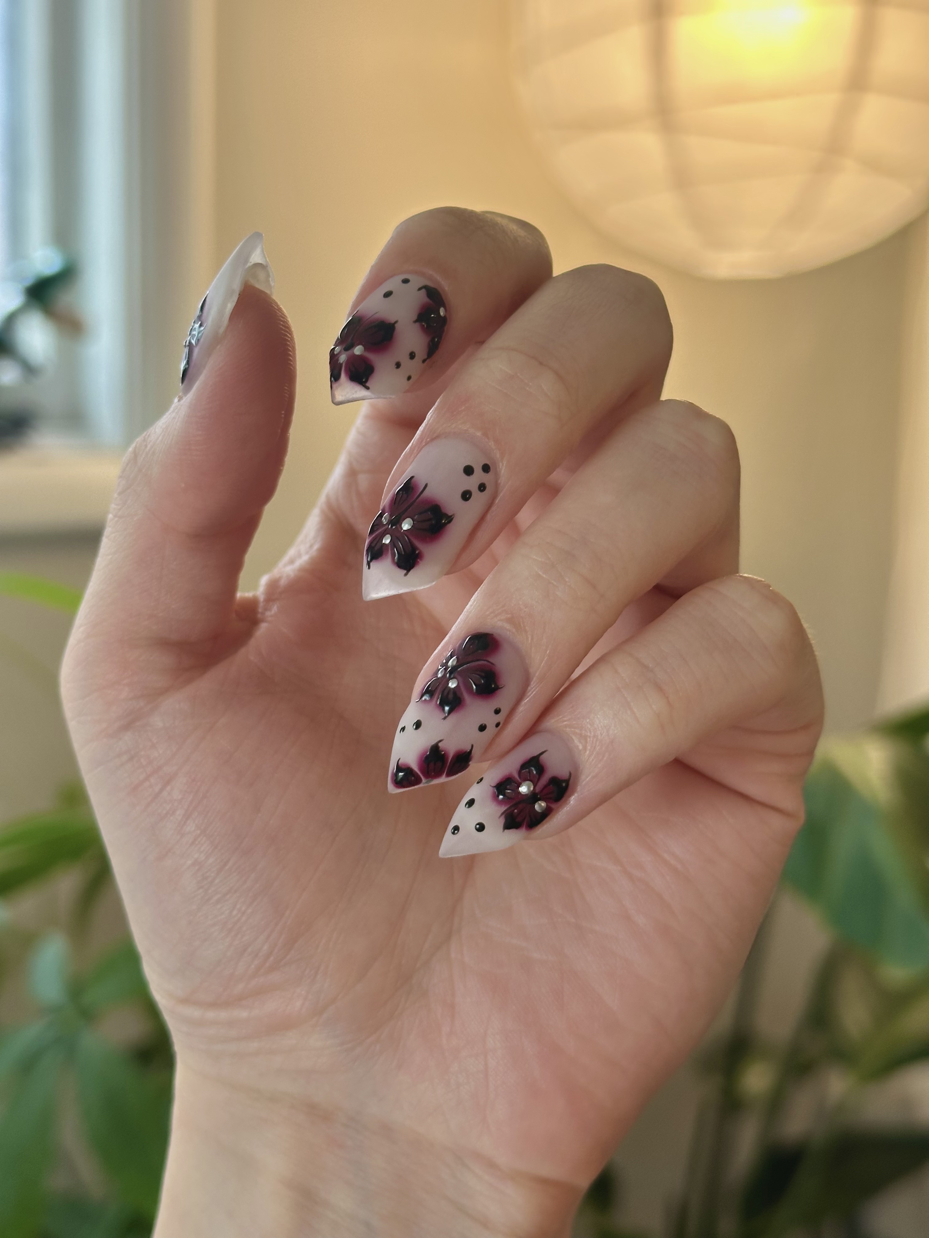 Zoe's acrylic nails. Cat claw style with black/wine red florals
